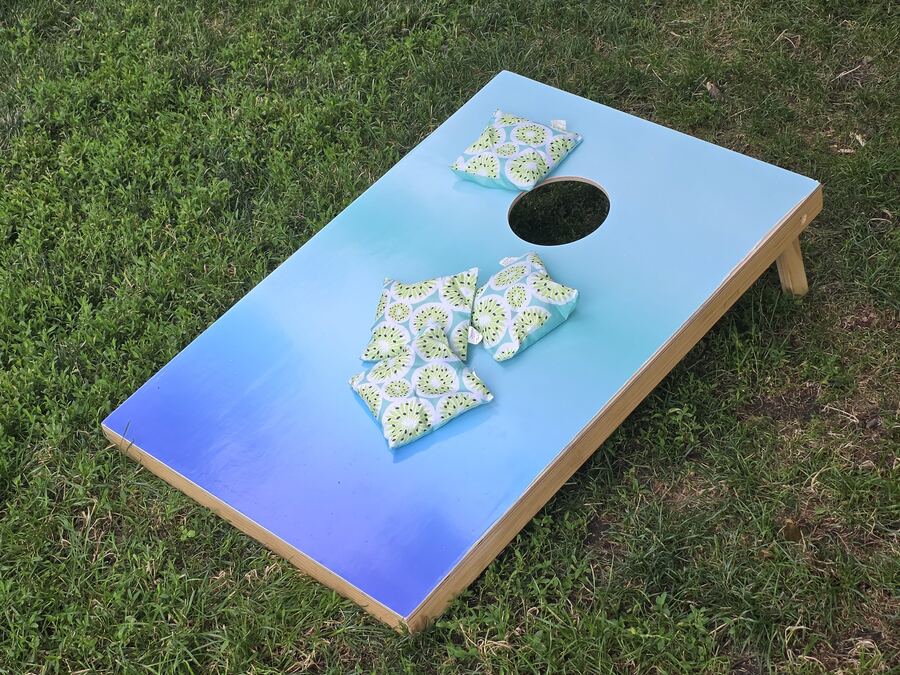 Corn hole boards and bags set up on the lawn